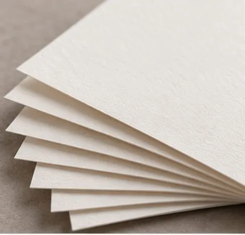 A fanned stack of heavyweight white paper showing the thick edges