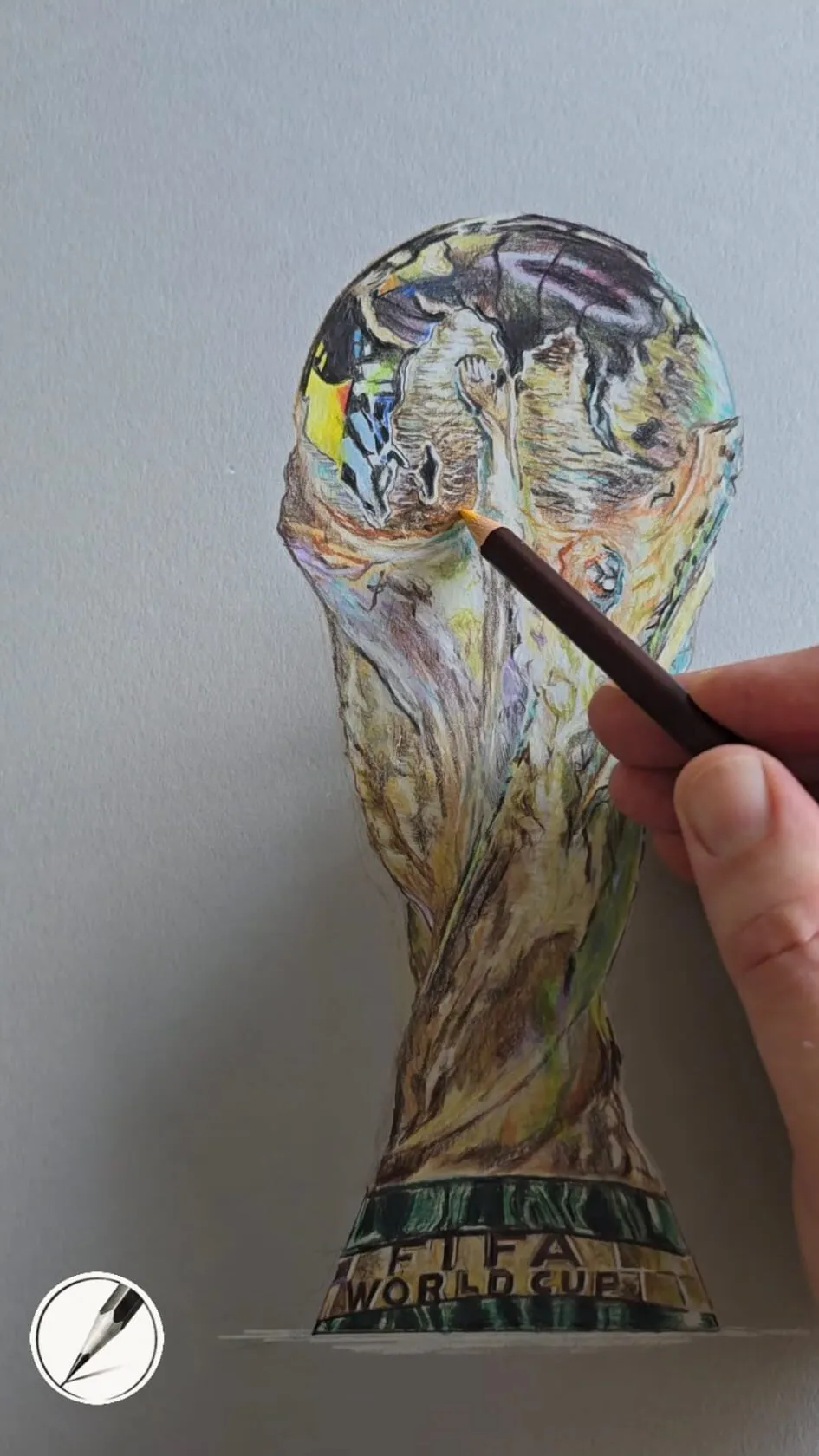 A hand drawing a gold trophy in coloured pencil on grey paper
