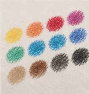 Round swatches of coloured pencil in yellow, orange, red, pink, green, blue, brown and black on cream paper